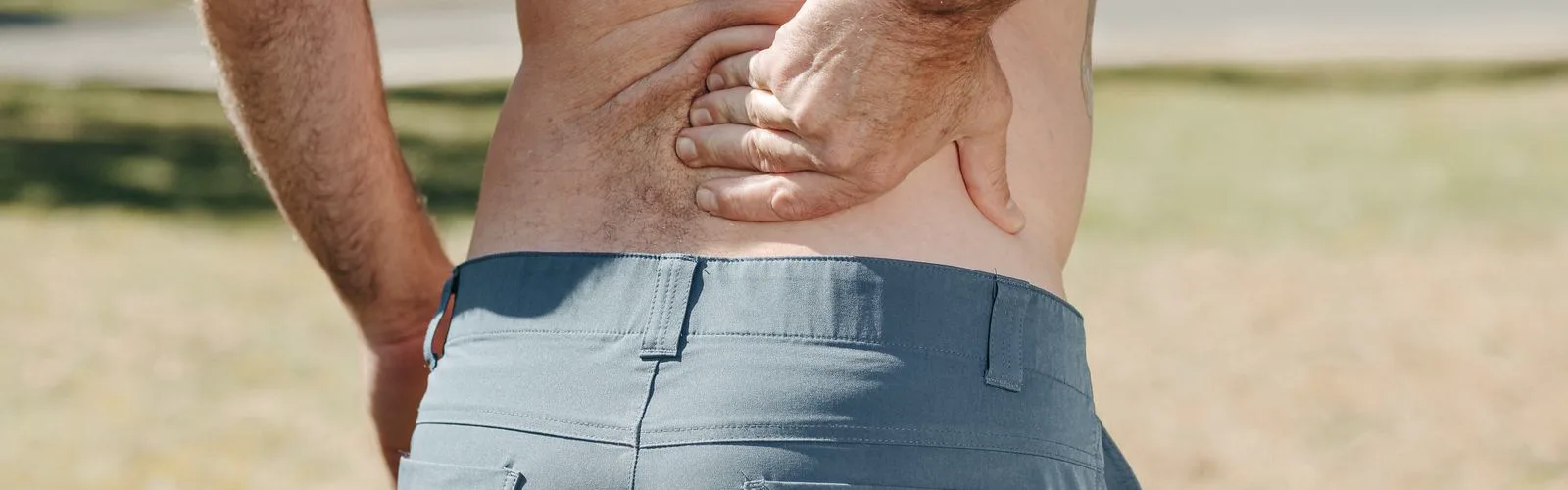 Man holding his lower back in pain